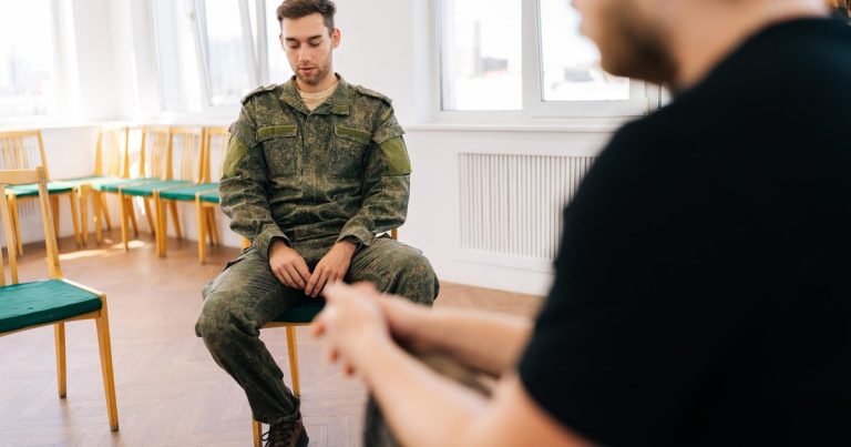 Psychologist speaking with a group of veterans in a training session
